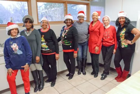 CYD volunteers in Santa hats at the Holiday Toy Giveaway